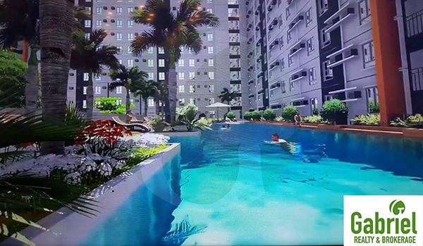 swimming pool area with beautiful flowery garden